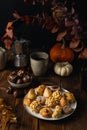 All Saints Day marzipan sweet panellets and roasted chestnuts, autumn leaves on wooden table Royalty Free Stock Photo