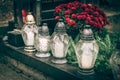 All Saints day, white burning candles on the grave Royalty Free Stock Photo