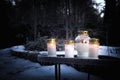 All Saints Day white grave candle lanterns lit in light snow in cemetery for remembering dead loved ones Royalty Free Stock Photo