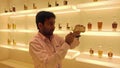 A perfumer wearing a white uniform mixing perfume in a perfumery, Bahrain Royalty Free Stock Photo