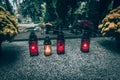 red burning candles on grave, All Saints Day, cemetery Royalty Free Stock Photo