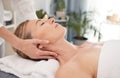 All stress is banished in this place. a mature woman enjoying a relaxing neck massage at a spa.