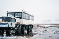 All-terrain vehicle on the background of mountains in Iceland. SUV for transporting people. Iceland transport in winter. Royalty Free Stock Photo