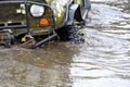 The all-terrain vehicle drove into a large water sharpens the wheels and the front part with headlights