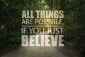 All Things Are Possible, If You Just Believe. Inspirational quote saying about power of faith. Text against beautiful forest and