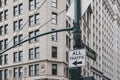 All traffic to left sign and Broadway street name sign on a street lamp post, against exterior of building in lower Manhattan Royalty Free Stock Photo