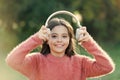All she wants to hear is music. Adorable little girl outdoor. Little girl child wearing headphones. Happy child enjoy Royalty Free Stock Photo