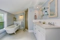 All white luxury master bathroom with vintage bathtub.