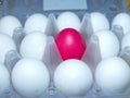 All white and one red upstart. All white and one red upstart. Red surrounded by white. Colorful Easter eggs are part of the Easter Royalty Free Stock Photo