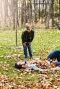 All you hear are giggles amongst the golden leaves. a father and his little son playing in the autumn leaves outdoors.