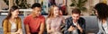 All you need is friends. Group of happy young multicultural people in casual wear looking at smartphone, enjoying time Royalty Free Stock Photo