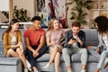 All you need is friends. Group of happy young multicultural people in casual wear looking at smartphone, enjoying time Royalty Free Stock Photo