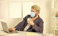 All you need for productive day. Totally protected. Wearing mask protect from coronavirus. Man in mask drink tea coffee