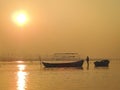 Landscape showing a lonely boatman on the Ganges river at sunrise in the city of Allahabad, India. Royalty Free Stock Photo