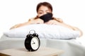 Allarm clock with sleepy Asian girl