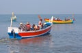 Indian fishermen catching fish for food in wooden boats