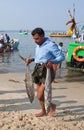 Indian fishermen unload the fish from the boat in Kerala, South Royalty Free Stock Photo