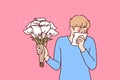 Allergic man holding bouquet flowers and using handkerchief suffering from pollen Royalty Free Stock Photo