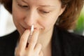 Allergic rhinitis, runny nose drops, woman with nasal spray at home Royalty Free Stock Photo