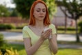 Allergie make trouble in nose! Young redhair woman sneezing. Pollen Allergy symptoms
