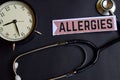 Allergies on the paper with Healthcare Concept Inspiration. alarm clock, Black stethoscope. Royalty Free Stock Photo