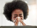 Allergies, sneeze and sick black woman blowing nose in home office with allergies, flu or cold in her home. Tissue Royalty Free Stock Photo