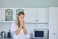 Allergies, toilet paper and woman blowing her nose in the kitchen for a cold, flu or sneeze at her home. Illness, virus