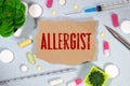 allergist colorful word on the wooden background with stethoscope