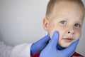 An allergist or dermatologist examines red spots on a childÃ¢â¬â¢s face. The boy suffers from a rash, hives and itching. Food Allergy