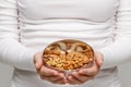 Allergy, healthy food, snack. Close up of woman hands with almond and bowl of mixed nuts Royalty Free Stock Photo