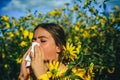 Allergy medical seasonal flowers concept. Woman with napkin fighting blossom allergie outdoor. Allergy to flowering