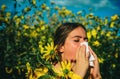 Allergy medical seasonal flowers concept. Woman with napkin fighting blossom allergie outdoor. Allergy to flowering