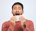 Allergy, sneeze and asian man is sick with tissue in studio with grey background with cold or sinus. Virus, allergies