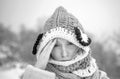 Allergy winter season. Woman having headache on snow background.