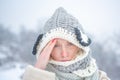 Allergy winter season. Woman having headache on snow background.