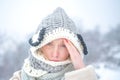 Allergy winter season. Woman having headache on snow background.