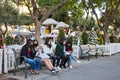 Girls enjoy looking at their mobiles at a bench in San Jose