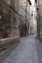 Alley of the city of Assisi with stone facades of historic houses. .Narrow alleys of the city with the walls of the stone houses.