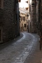 Alley of the city of Assisi with stone facades of historic houses. .Narrow alleys of the city with the walls of the stone houses.