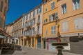 Alley with colorful buildings, shop and fountain in Aix-en-Provence. Royalty Free Stock Photo