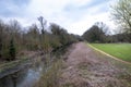 Alley in Cranford Park and the river Crane on an overcast day Royalty Free Stock Photo