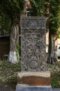Stone khachkar with the figure of the virgin and child, angels and the Sun-a symbol of eternity in Gyumri