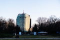 Alley of Greek statues in the Herastrau park and the high rise business building in Aviatorilor Square Royalty Free Stock Photo