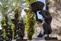 Alley with large identical stone statues of the Egyptian God Anubis on a summer sunny day