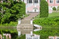 Alley leading to manorhouse and pond with pier in front Royalty Free Stock Photo