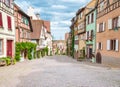 Alley in medieval Riquewihr town on wine route Alsace. Riquewihr known for the Riesling and other great wines produced in the Royalty Free Stock Photo