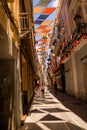 Alley with multi-colored shade awnings in the center of Badajoz