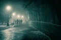 Alley of a night winter park in a fog. Footpath in a fabulous winter city park at night in fog with benches and latterns.