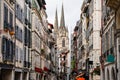 Alley with old buildings and cathedral towers in the background in the city of Bayonne in the south of France. Royalty Free Stock Photo