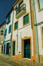 Alley of old colorful houses with worn plaster wall